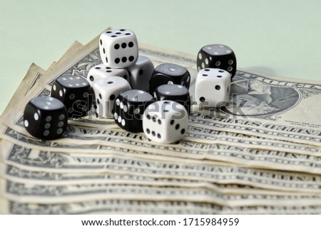 Playing a game with dice. Rolling the dice concept for business risk. Risk concept.many american dollar banknotes