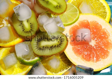 mix of fruits and ice, close-up of kiwi lime grapefruit. flat lay. top view, copy space.