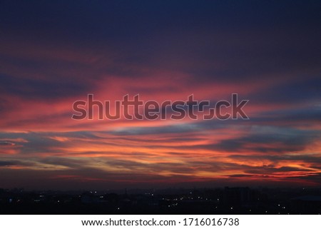 Natural Sunset Sunrise Over Field Or Meadow. Bright Dramatic Sky And Dark Ground. Countryside Landscape Under Scenic Colorful Sky At Sunset Dawn Sunrise. Sun Over Skyline, Horizon. Warm Colours. Royalty-Free Stock Photo #1716016738