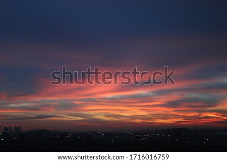 Natural Sunset Sunrise Over Field Or Meadow. Bright Dramatic Sky And Dark Ground. Countryside Landscape Under Scenic Colorful Sky At Sunset Dawn Sunrise. Sun Over Skyline, Horizon. Warm Colours. Royalty-Free Stock Photo #1716016759