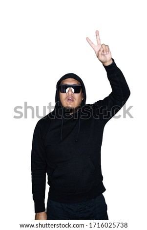 Bearded asian men dressed in black hoody is showing victory sign in white background.The concept of protest, attention, request. Place for text or copy space. Clipping path.