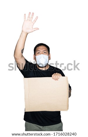 Bearded asian men worker dressed in black tees with medical mask and holding cardboard open hand doing stop sign in white background.The concept of protest. Place for text or copy space. Clipping path