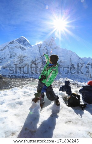 trekker and flare over nuptse summit beside of everest from kallapather summit