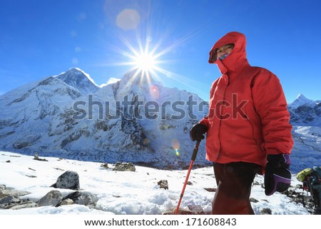trekker and flare over nuptse summit beside of everest from kallapather summit