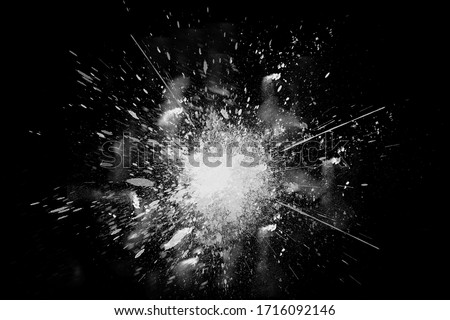 Freeze motion of white paint powder exploding, isolated on black, dark background. Abstract design of white dust cloud. Particles explosion screen saver, wallpaper copy space. Planet creation concept Royalty-Free Stock Photo #1716092146