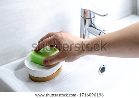 Hand washing with soap. Preventive measures against infection. A young guy washes his hands with soap in the bathroom. Body hygiene. The fight against COVID-19