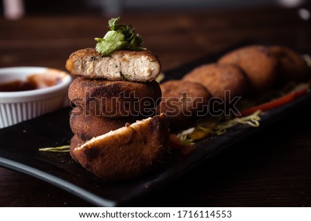 Dahi kebab or Dahi Ke Angare is a popular snack item from India served with ketchup wooden background selective focus