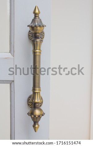 Door handle on the white door