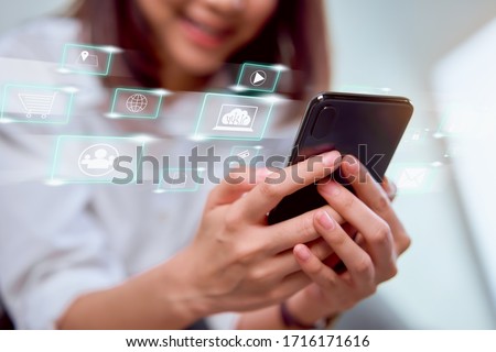 Concept technology internet and networking, smile woman hand holding smartphone with media icon on digital display.