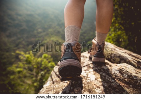 Successful hiker enjoy the view on mountain top cliff edge Royalty-Free Stock Photo #1716181249