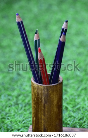 Beautiful wooden pen stand on green grass