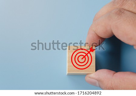 Business success strategy concept, Marketing Victory.Hand chooses wooden block symbol with goal target icon.
