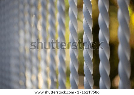 Spiral rods of a fence with a blurry background