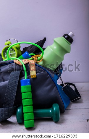 Sports bag with equipment on wooden floor. Creative concept of sport and fitness equipments