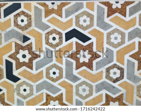 Geometric hexagon and star floral wall tile pattern close up on masjid mosque in Morocco  