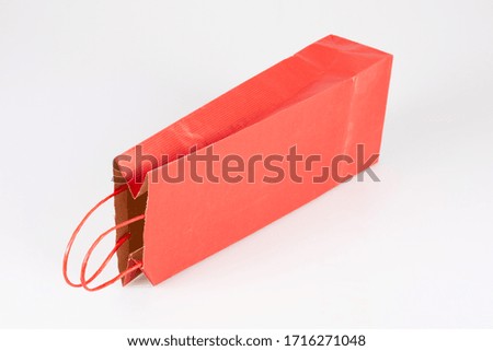 Orange red shopping gift bootle bag isolated on white background