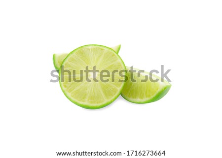A fresh green lime and a piece of slice lice