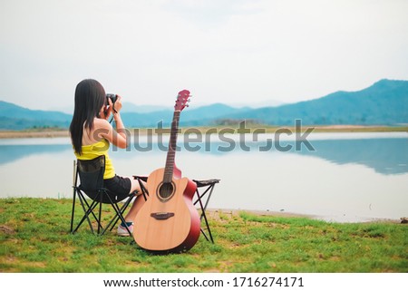 woman traveler have camping and picnic alone near the lake on vacation. 