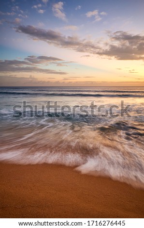 Tropical beach at golden sunset, long exposure picture.