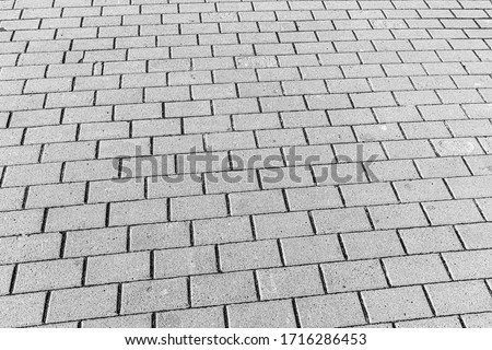 Top view on gray paving stone road. Old pavement of granite texture. Street cobblestone sidewalk. Abstract backdrop for design.