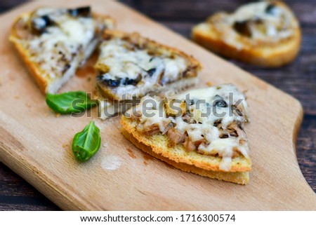Pizza toasted bread with  tuna,olives,mushrooms and mozzarella cheese. Selective focus, picture vintage style 