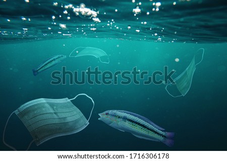 Photo manipulation about ocean pollution. Consequences of overuse of surgical masks during the coronavirus pandemic. Royalty-Free Stock Photo #1716306178