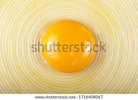 Raw yolk on middle of linguines spaghetti arranged in circle. Top view. Overhead. Close up
