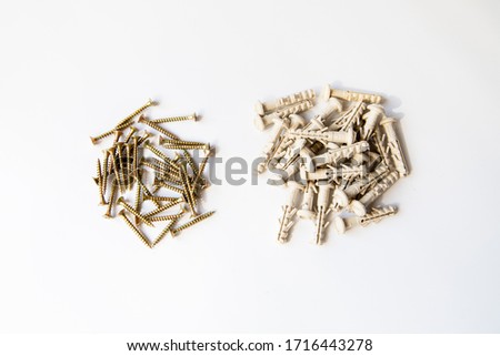 tapping screws made of steel with plastic dowels, metal screw, iron screw, chrome screw, screws as a background, wood screw, white background