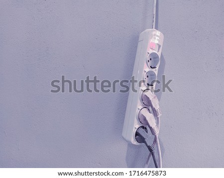 electrical plugs hanging on the wall
