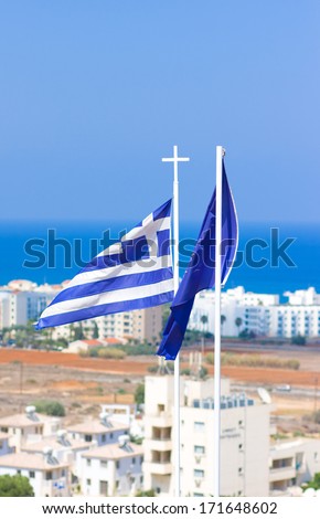 Flags of Greece and European Community against white houses and sea