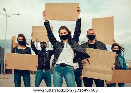 group of people with mask came out with posters to protest The population against coronavirus and against the introduction of quarantine Meeting about coronavirus and people right. copy space