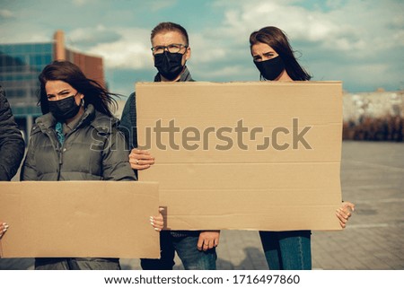 group of people with mask came out with posters to protest The population against coronavirus and against the introduction of quarantine Meeting about coronavirus and people right. copy space