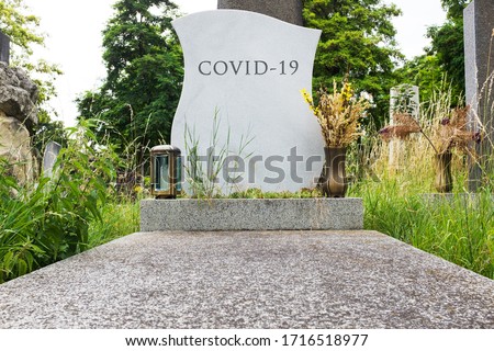 Headstone tombstone or gravestone with COVID-19 letters carved in, Coronavirus global pandemic crisis, many victims and deaths, deadly virus disease, acute respiratory pneumonia infection, RIP concept Royalty-Free Stock Photo #1716518977