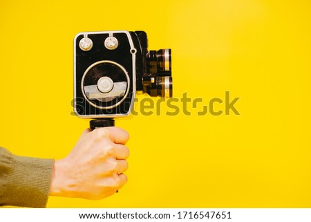 Retro camera. Hand holds a retro video camera.
