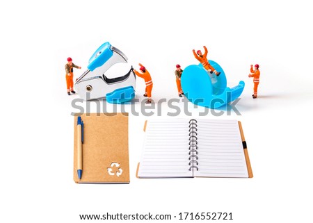 selective focus of miniature workers man with stationery isolated on white background, 