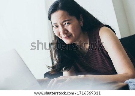 using computer.hand typing keyboard laptop online chatting search form internet while working sitting on sofa.concept for work from home.technology device contact communication business people