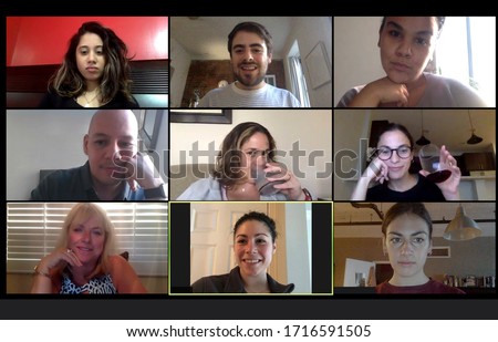 Shot of a screen of teammates doing a virtual happy hour from their home offices.  Team meeting from home during COVID-19 coronavirus pandemic. Royalty-Free Stock Photo #1716591505