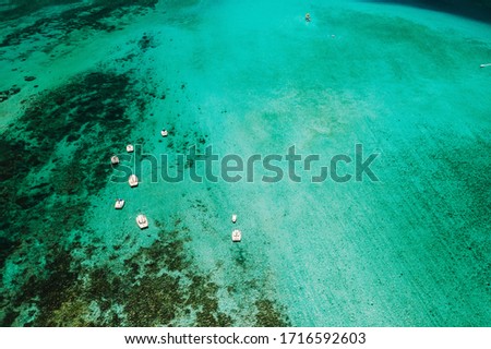 Aerial picture of the east coast of Mauritius Island. Beautiful lagoon of Mauritius Island shot from above. Boat sailing in turquoise lagoon