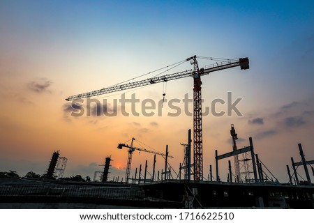 New construction site with crane and mechanical equipments on sunset background. Royalty-Free Stock Photo #1716622510