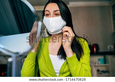 Image of Caucasian woman blogger wearing mask during quarantine, creating new content for her blog on social networks. Female wears mask to protect from virus. Coronavirus, internet, blogging.