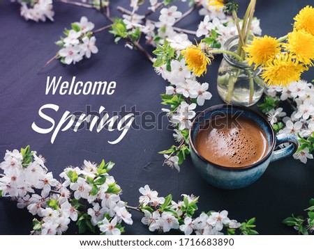 Welcome spring, a Cup of fragrant coffee and cherry blossoms on the table
