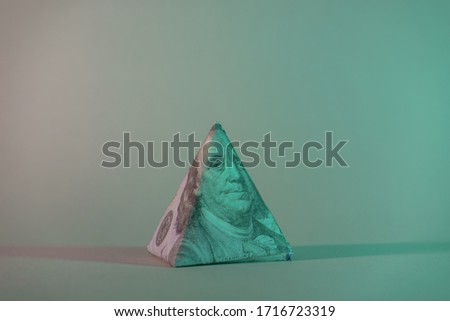 Close up Franklin's face pyramid  on a one hundred dollar. American, US Dollars Cash Money in neon light.Minimalism retro style concept. 80s. Background pattern for design.