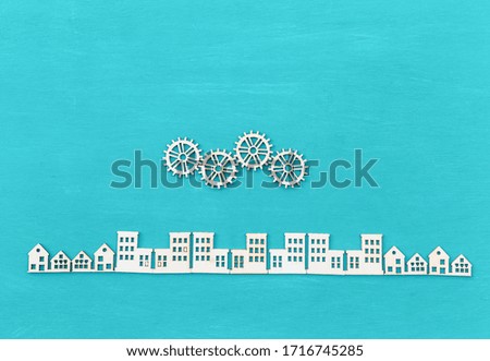 Wood craft on blue texture background, wood gear over wood city