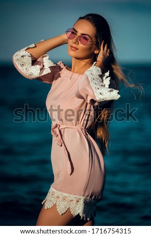 Young beautiful gorgeous pretty face female model pose at the evening beach