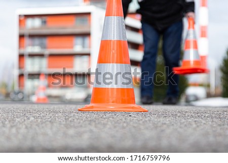 Orange gray white isolated traffic sign front and center on asphalt matching background