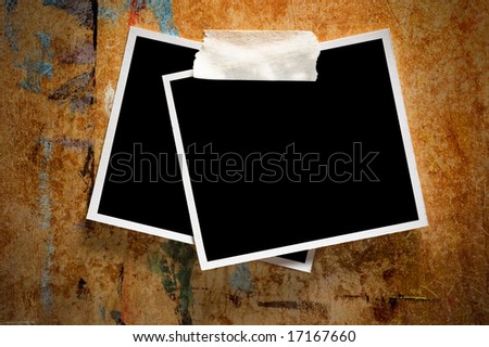 Two instant photo frames on a grungy wooden background