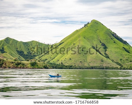 Boat with small island in Indonesia. 