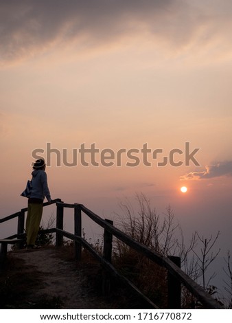 girl watching sunrise in morning trek