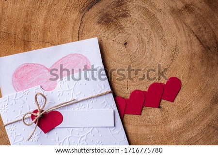 
Mother's Day concept. With a gift, red hearts and card, on a wooden background