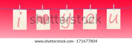 Letters hanging from a clothes line spelling I love you with a heart